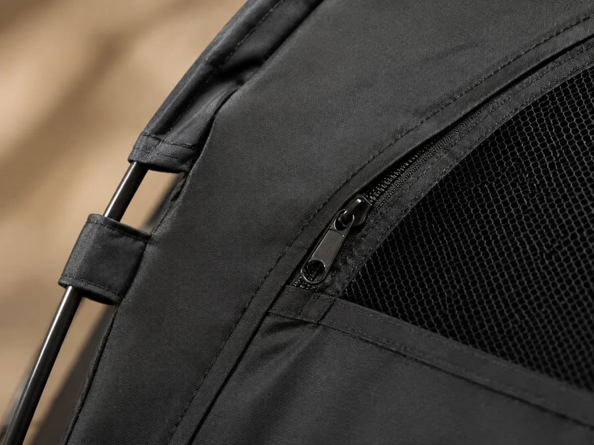 Illustrative close-up of blackout fabric, zipper, and mesh detail
